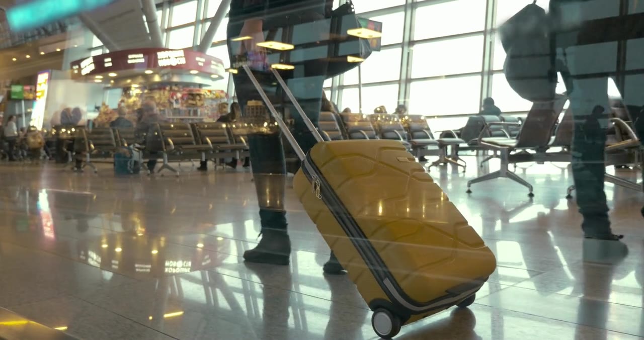 A rolling suitcase, shown as placeholder footage for the StrumBuggy website